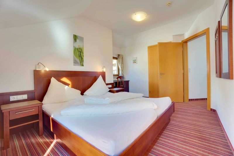 Bedroom with double bed and balcony in Apartment Type I