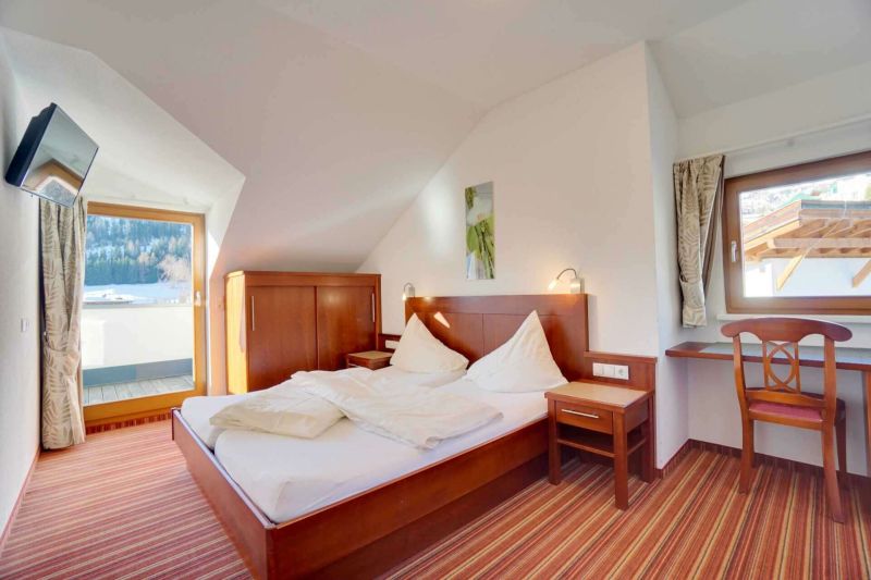 Bedroom with double bed and balcony in Apartment Type I
