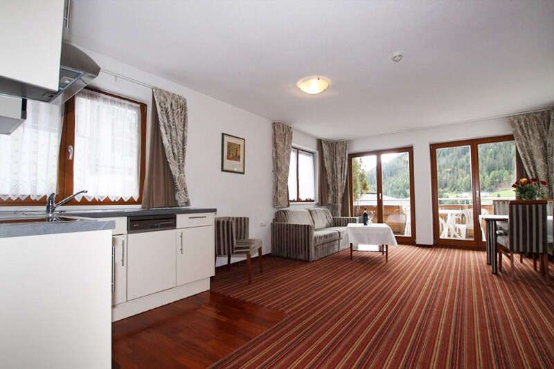 Kitchen-living room with balcony in apartment type H in Hotel Philipp