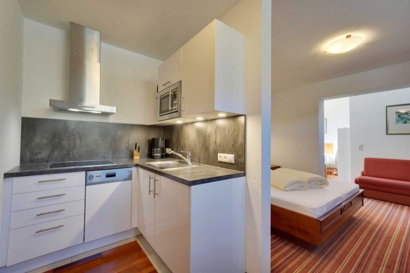 Bedroom with double bed and balcony in Apartment K