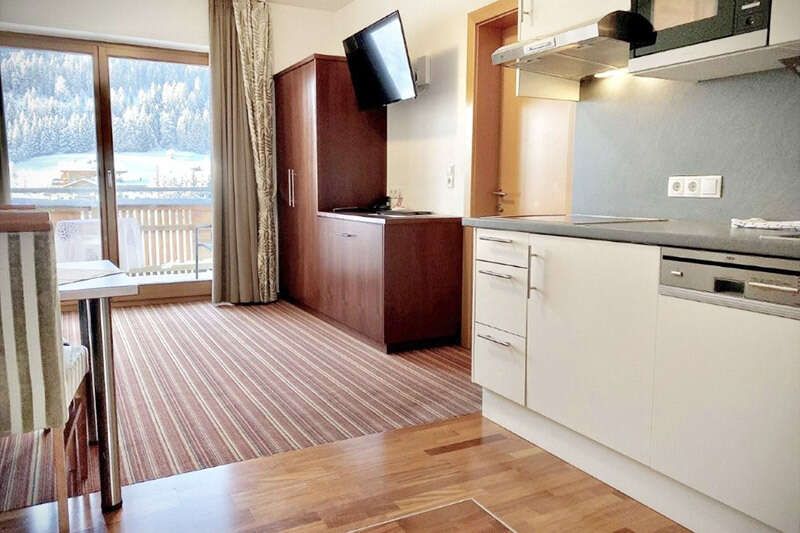 Kitchen-living room with TV in Apartment Type I
