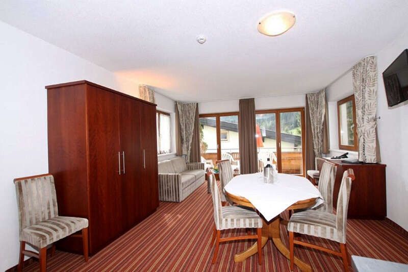 Living room with balcony in apartment type D in Hotel Philipp