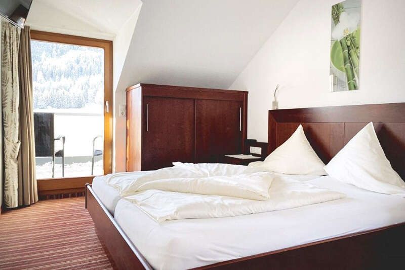 Bedroom with balcony in Apartment Type I in Hotel Philipp