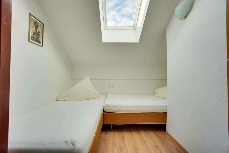 Bedroom with two single beds for children in Apartment C